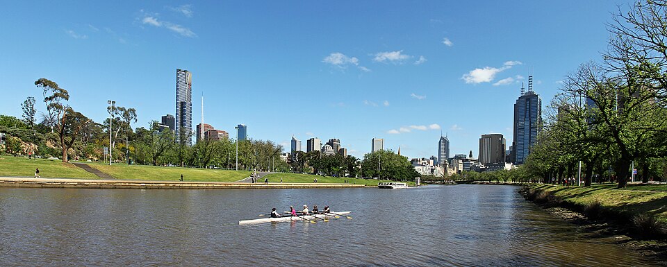 Walking paths and greenery beside Melbourne’s Yarra River with the skyline beyond